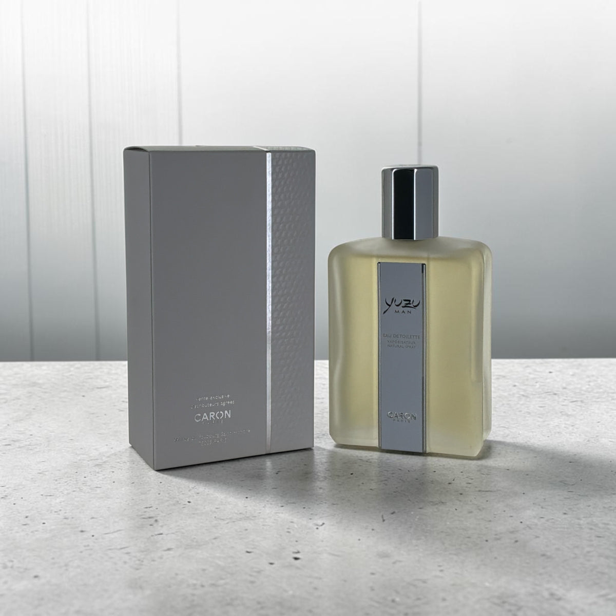 Yuzu Man Caron fresh citrus cologne for men, bottle next to its packaging"