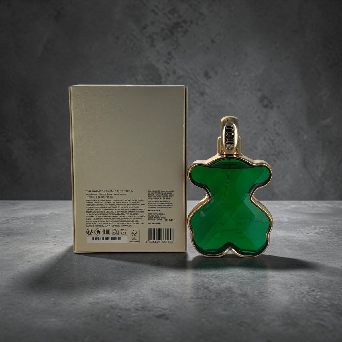 "LoveMe The Emerald Elixir Tous floral gourmand perfume for women, emerald green bottle next to its packaging"