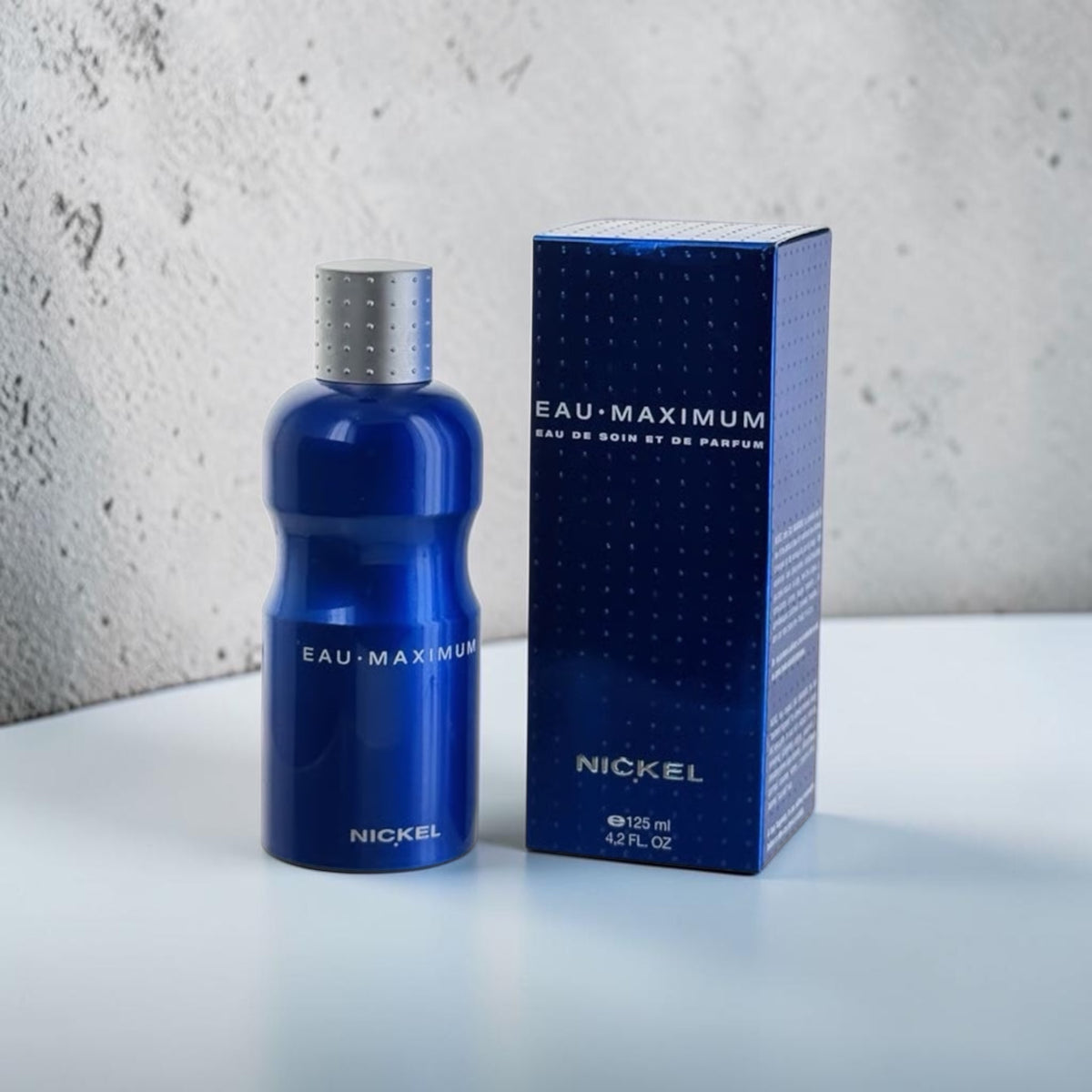 "Nickel Eau Maximum active treatment fragrance spray, metallic blue bottle"