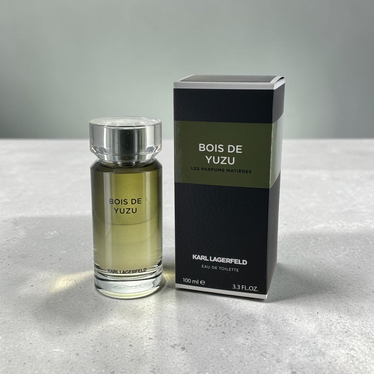"Bois de Yuzu Karl Lagerfeld fresh citrus spicy cologne for men, bottle next to its packaging"