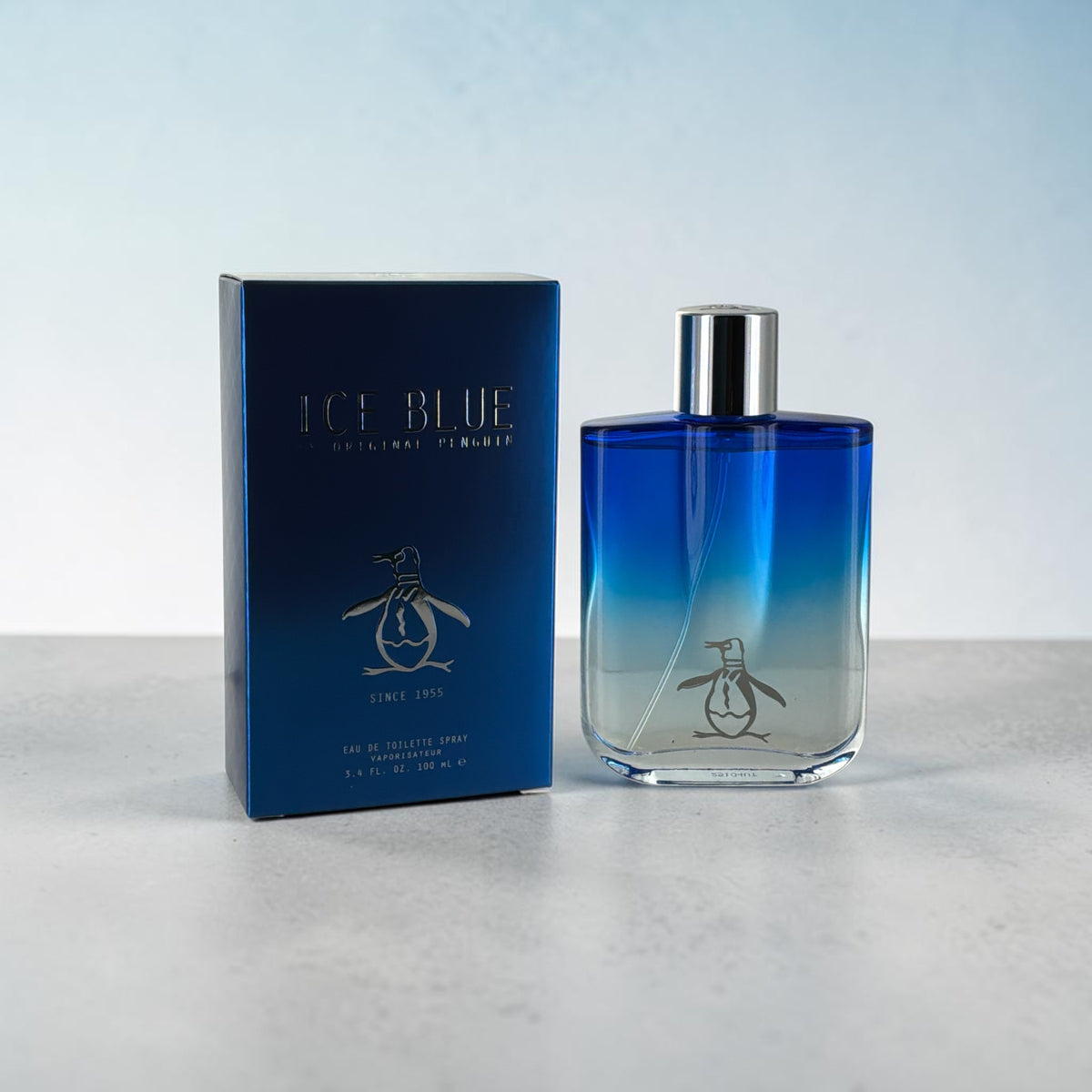 "Original Penguin Ice Blue men's cologne with bergamot, lavender and cedar notes, front view"